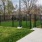 a sidewalk and a fence surrounding a dog park