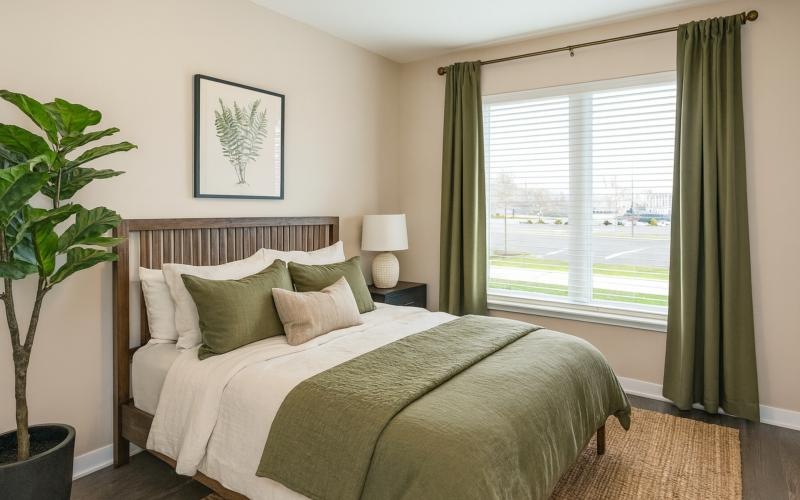a bedroom with a bed and a large window