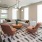 a lounge room with a couch and chairs