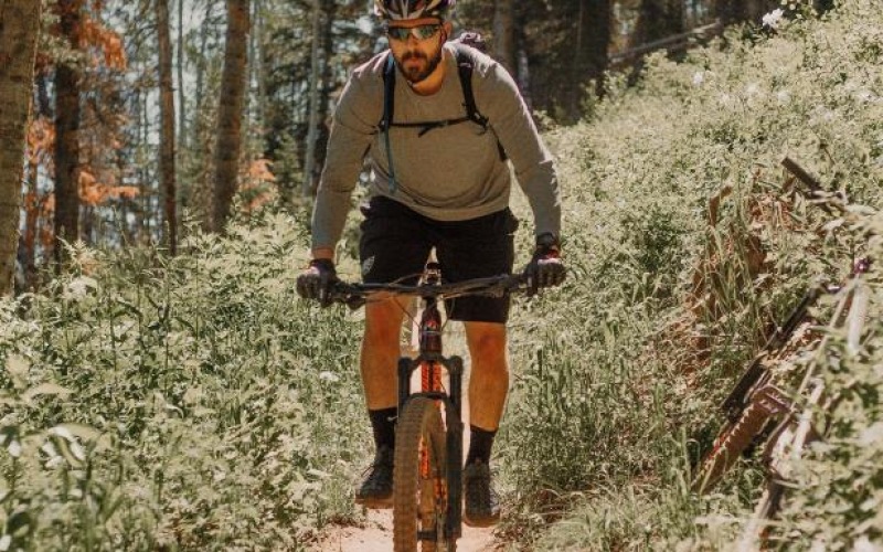 man riding a bike on a trail in the woods