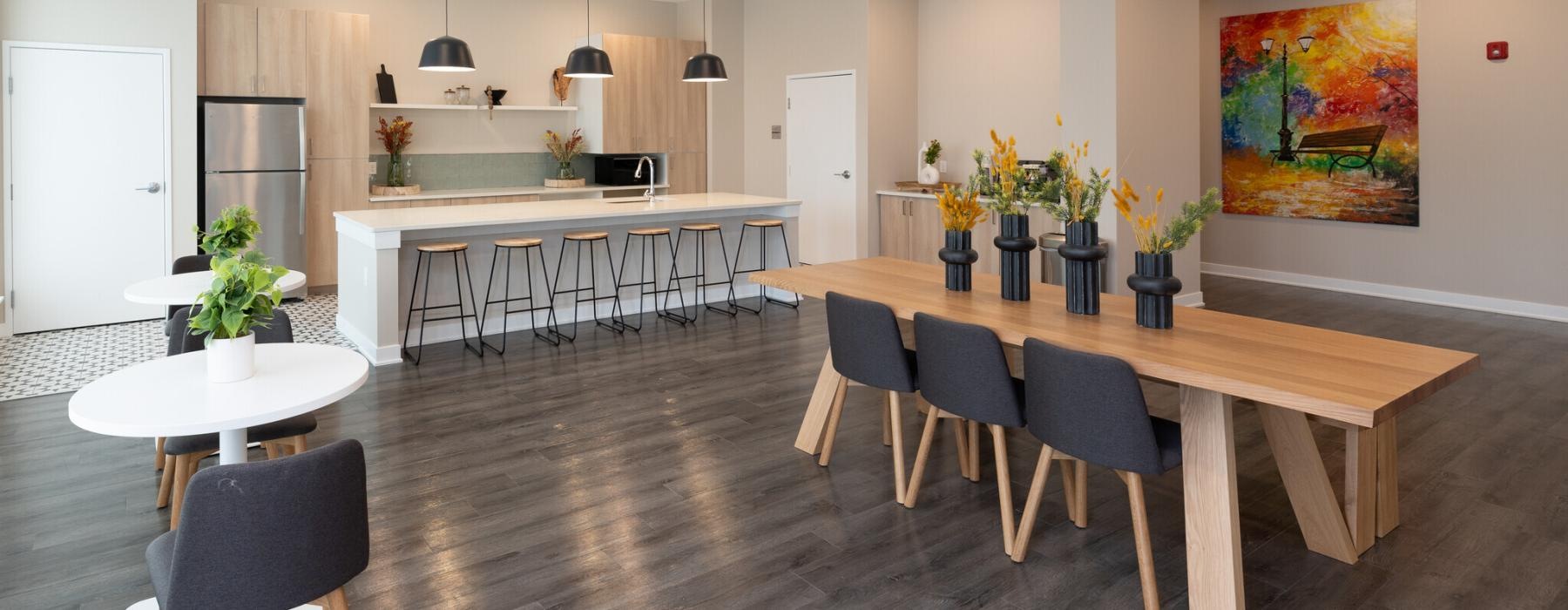 a large room with a dining table and bar and chairs