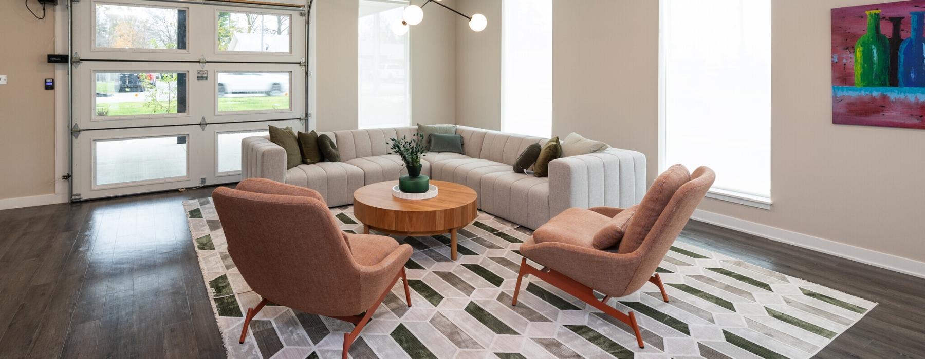 a lounge room with a couch and chairs