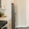 a kitchen with white cabinets a stovetop and a fridge